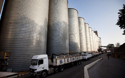 Trucks wait to be loaded with grain in Mombasa, Kenya. Legal delays that are inefficient and avoidable are causing hunger worldwide. Picture: BLOOMBERG